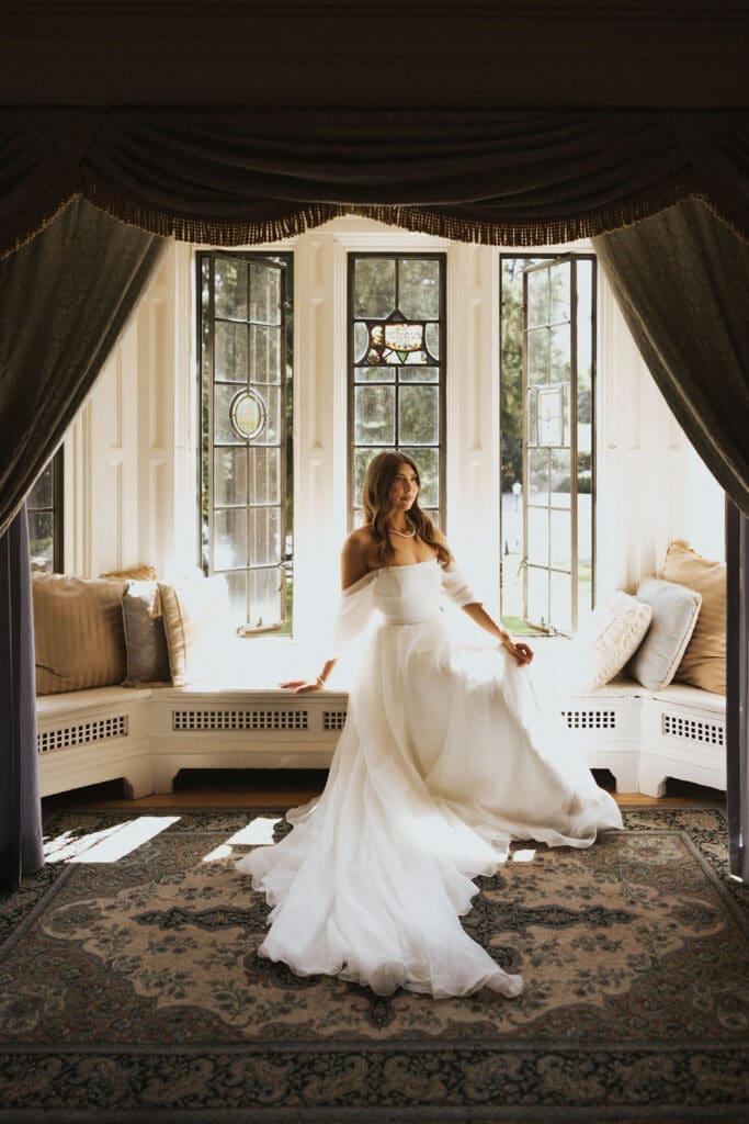 Editorial bridal portrait by a historic bay window during an elegant Washington estate wedding, photographed by Seattle wedding photographer Valen Lee Photography.