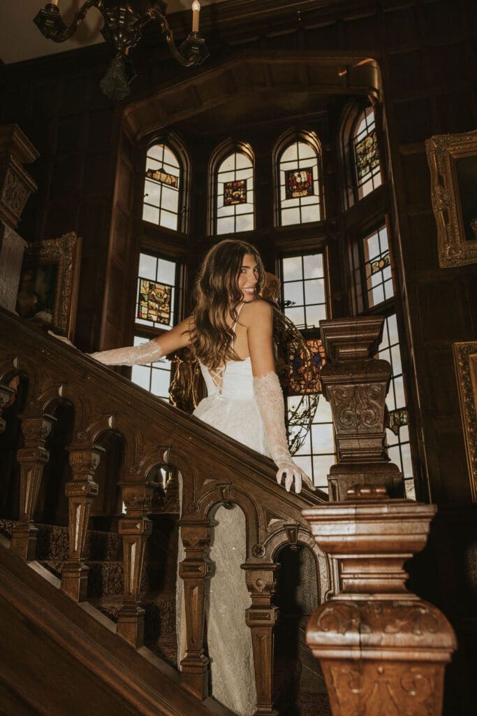 Editorial bridal portrait on an ornate wooden staircase inside a historic Washington estate wedding venue.