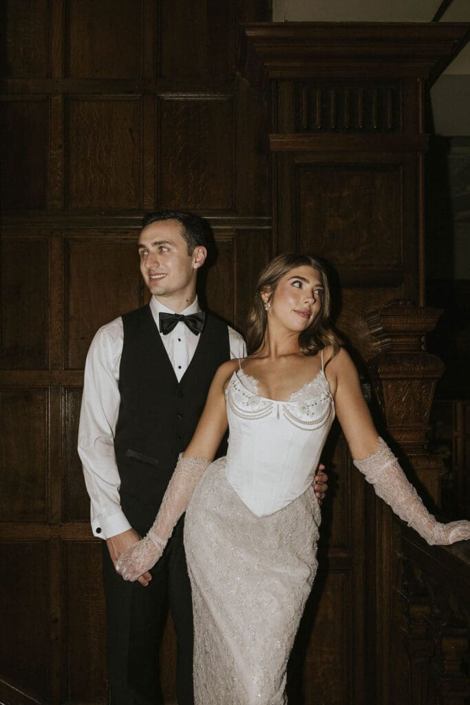 Bride and groom posing together against dark wood paneling for an elegant editorial wedding portrait in Washington.