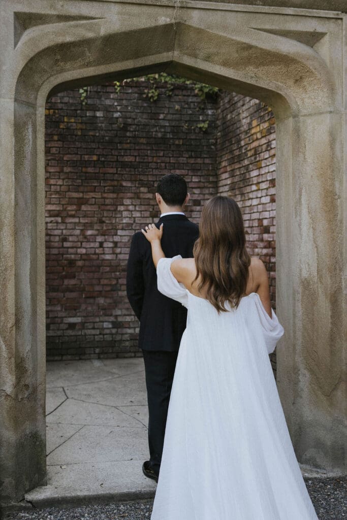 Bride walking toward the groom for their first look at a historic Washington wedding venue.